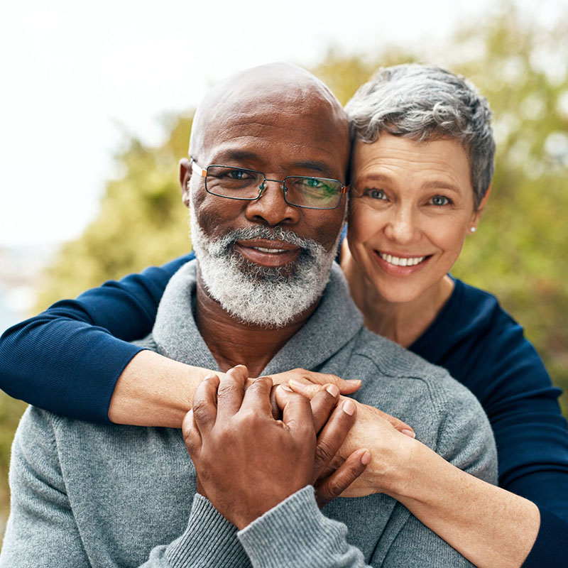 interracial mixed race elderly couple hugging